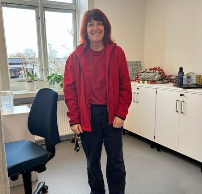 Photo of a woman using a red jacket, a red t-shirt with black pants, showcasing the uniforms