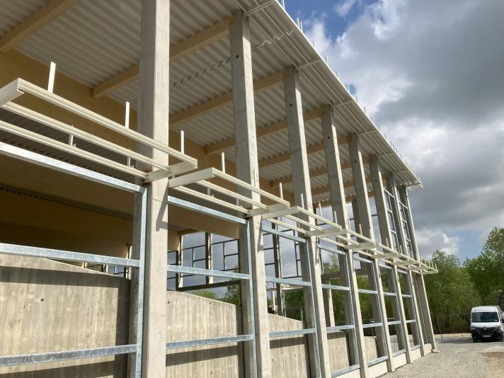 Image of a building under construction, light beige in colour.