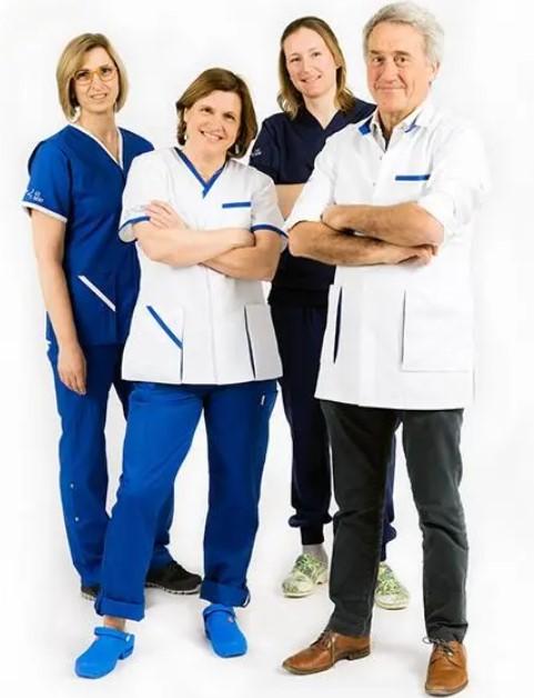 Picture of the hospital workwear provided by SARCO. Four medical staff are show on a white background dressed in the different uniform models. 