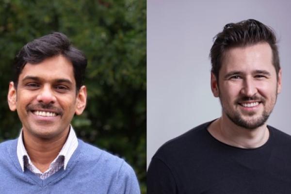 Image of two male persons smiling at the camera. 